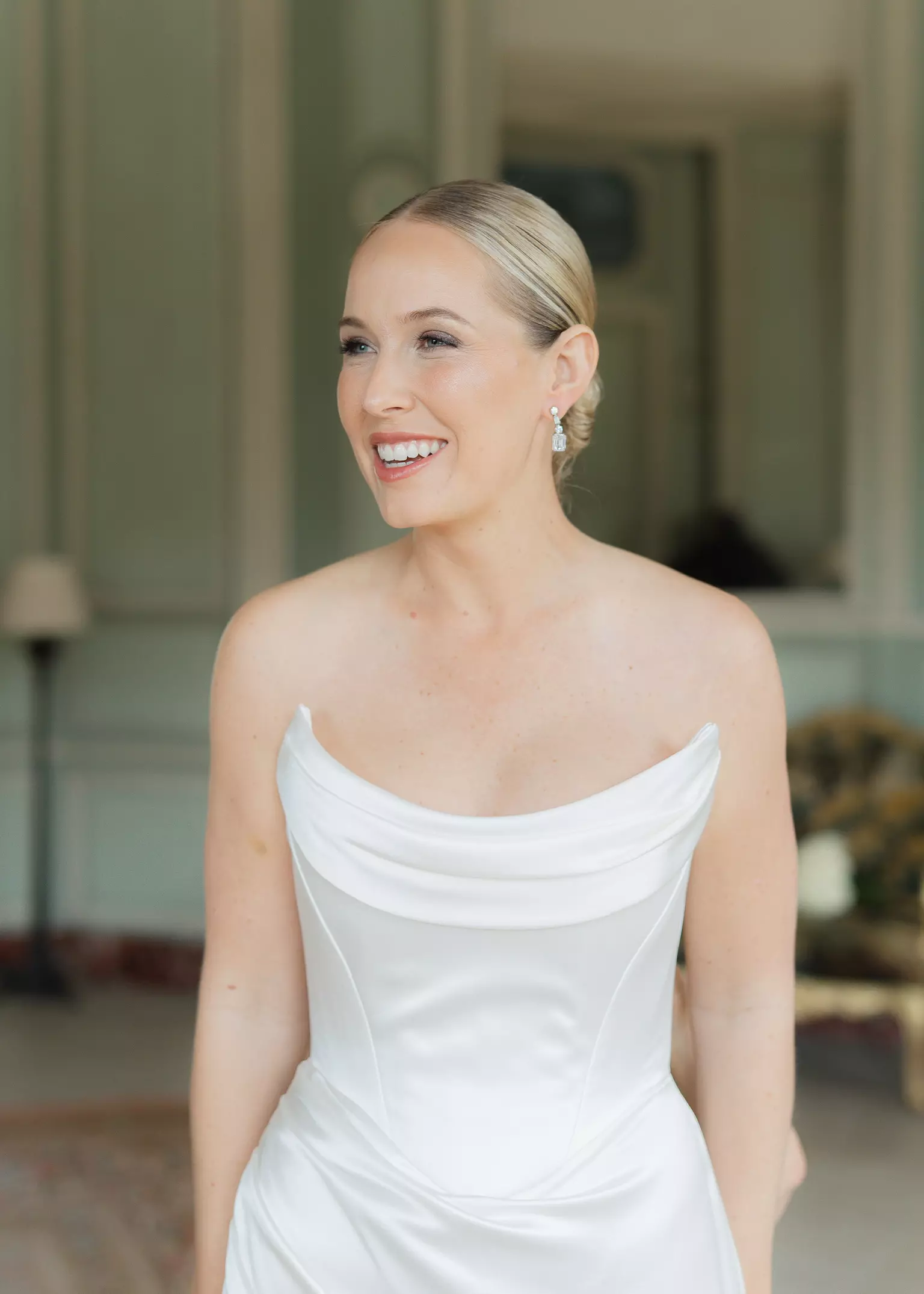 Bride Stéphanie with refined natural bridal makeup and sleek low bun hairstyle designed for long wedding day