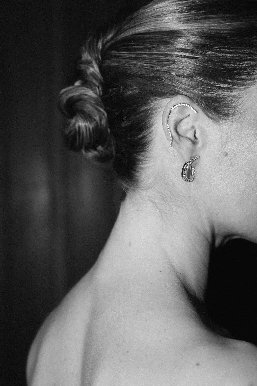 Close up black and white portrait of bride showing refined low bun bridal hairstyle created by Mandy Dorian luxury bridal hair artist in France
