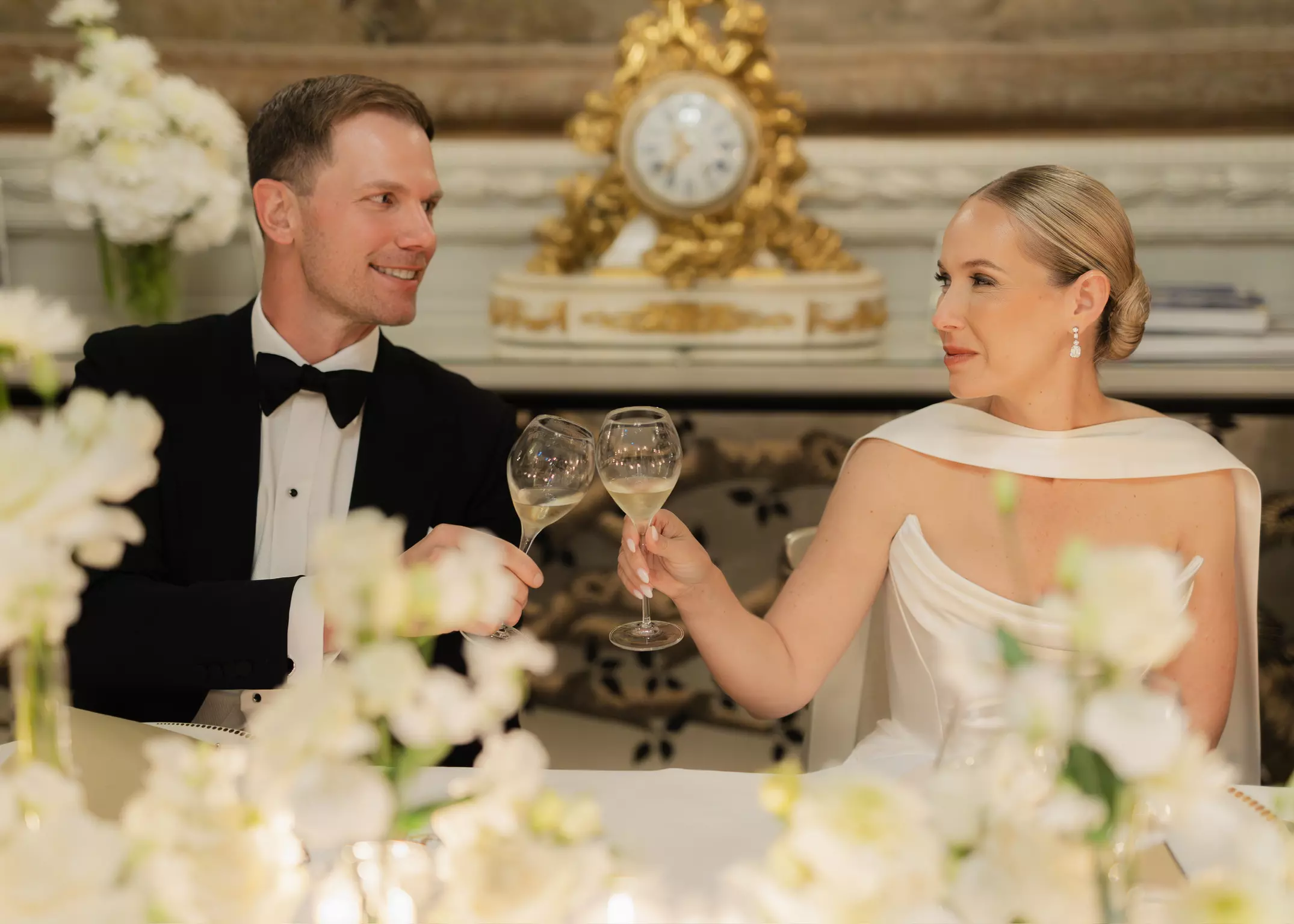 Bride and groom toasting at Hôtel de Crillon with flawless bridal makeup and structured hairstyle by Mandy Dorian