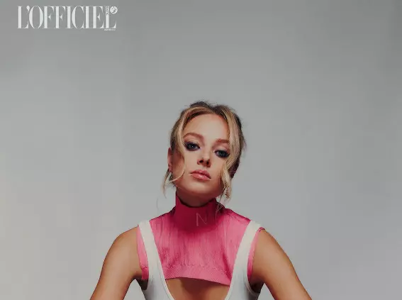 Model wearing pink high neck top with structured editorial makeup and styled updo by Mandy Dorian for fashion magazine shoot