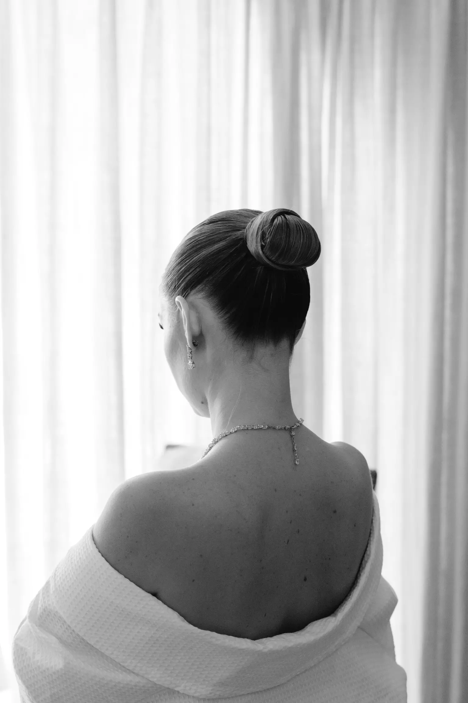 Back view of sleek bridal bun showcasing technical hairstyling expertise by Mandy Dorian
