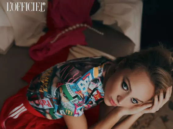 Model wearing colorful outfit with refined editorial makeup and styled updo for L’Officiel magazine