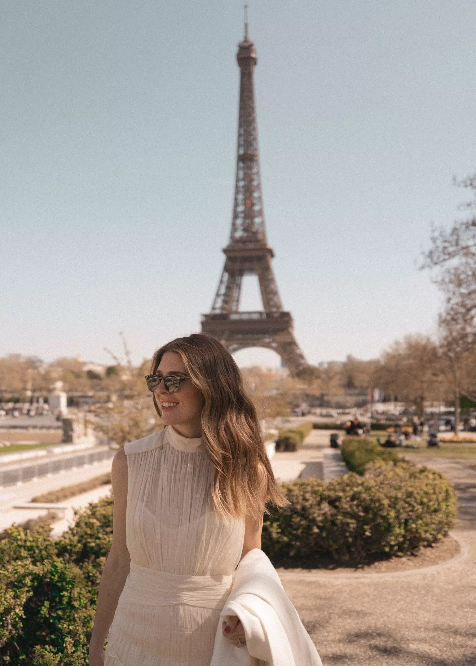 Bride Liz near Eiffel Tower wearing soft romantic bridal hair and natural luminous makeup by Mandy Dorian