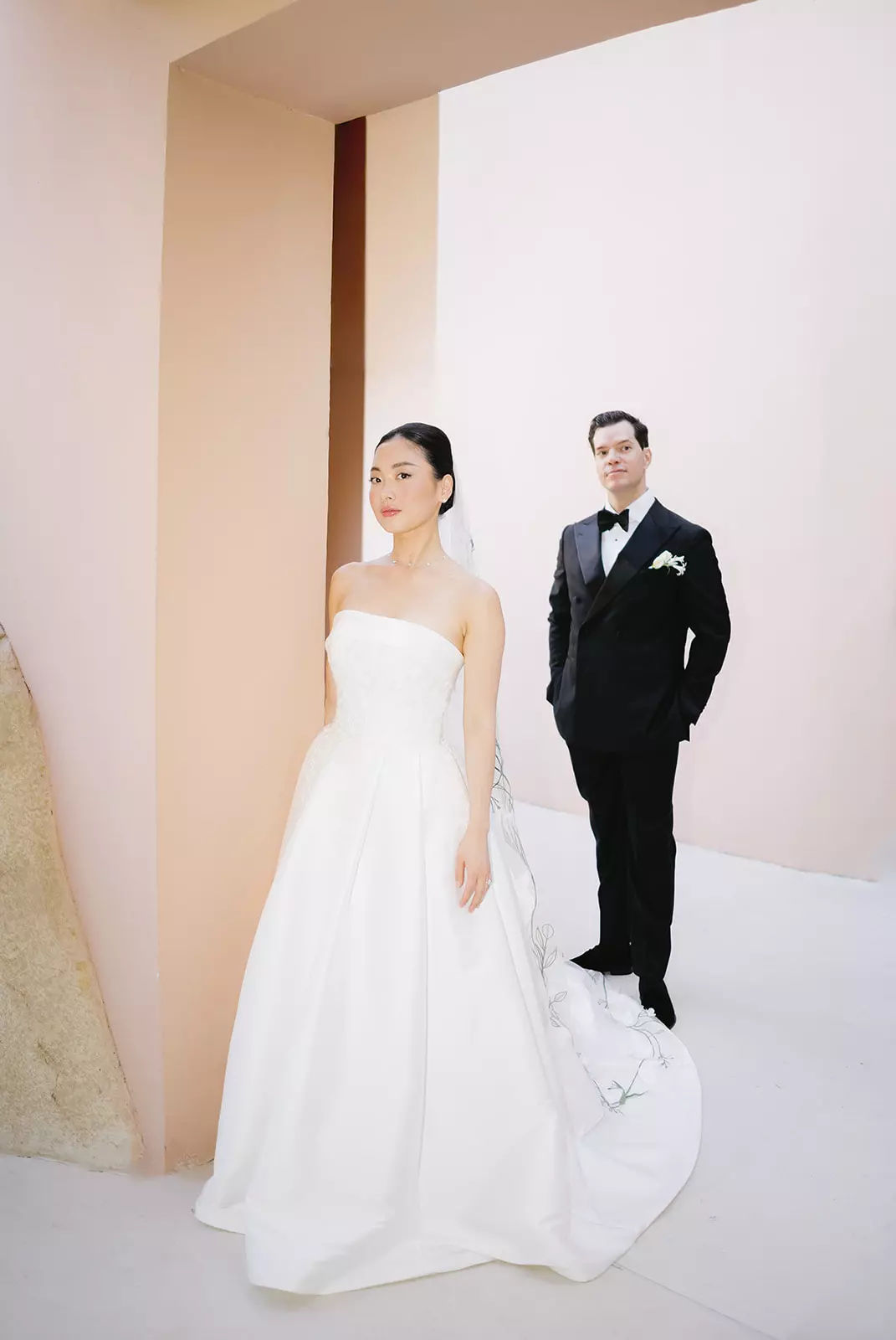Bride and groom standing together featuring refined bridal hair and luminous natural makeup by Mandy Dorian