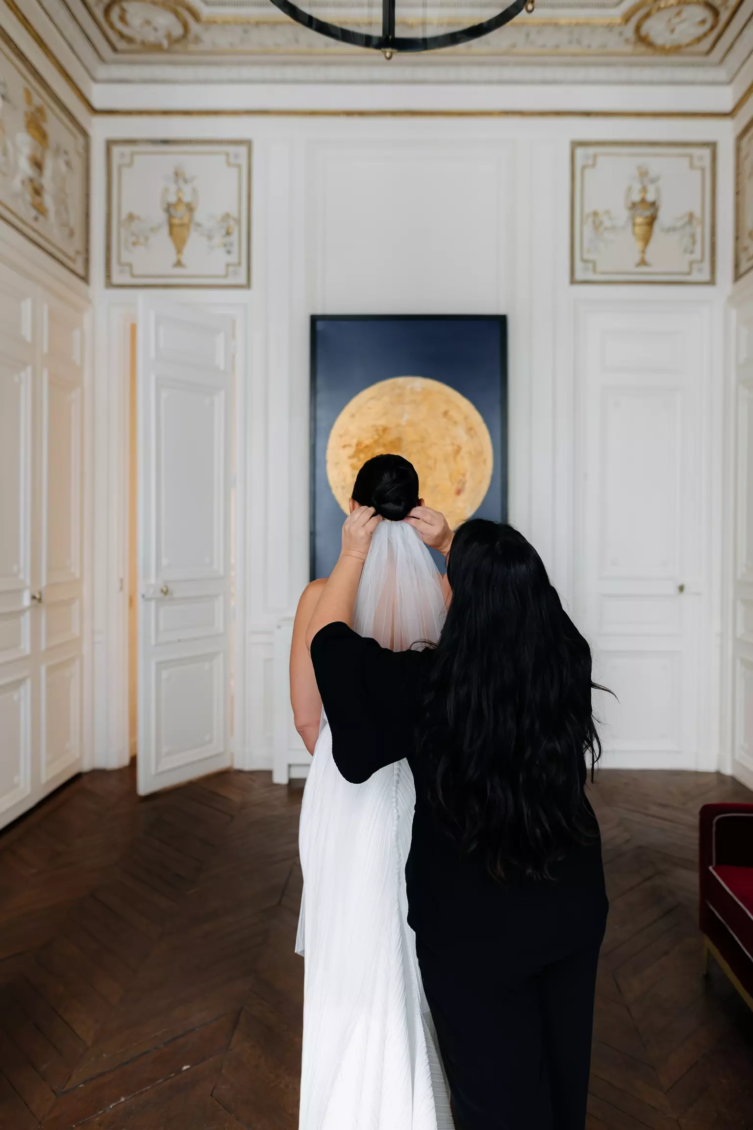 Mandy Dorian adjusting bride’s veil ensuring flawless bridal hairstyle before ceremony in Paris