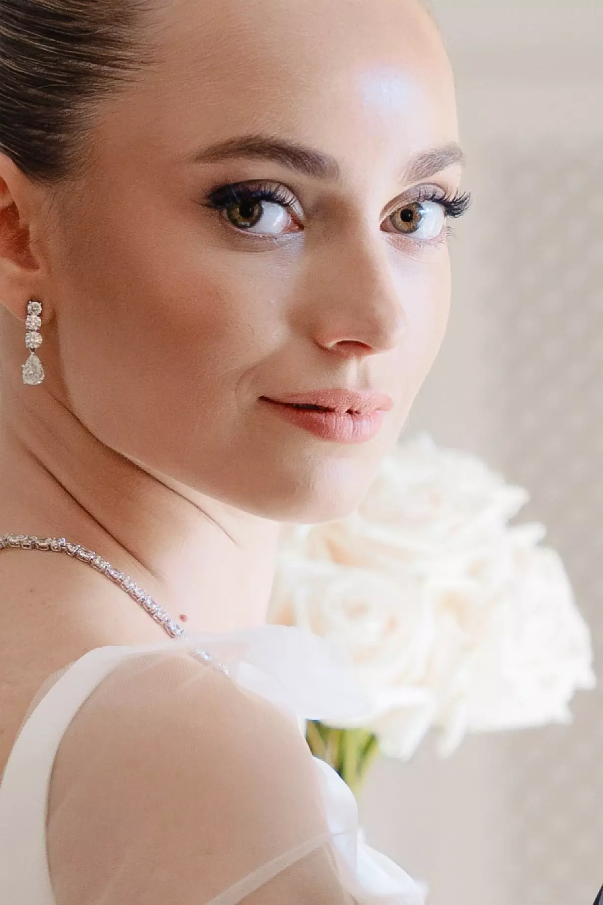 Close portrait highlighting glowing skin and elegant bridal makeup designed for long wedding day