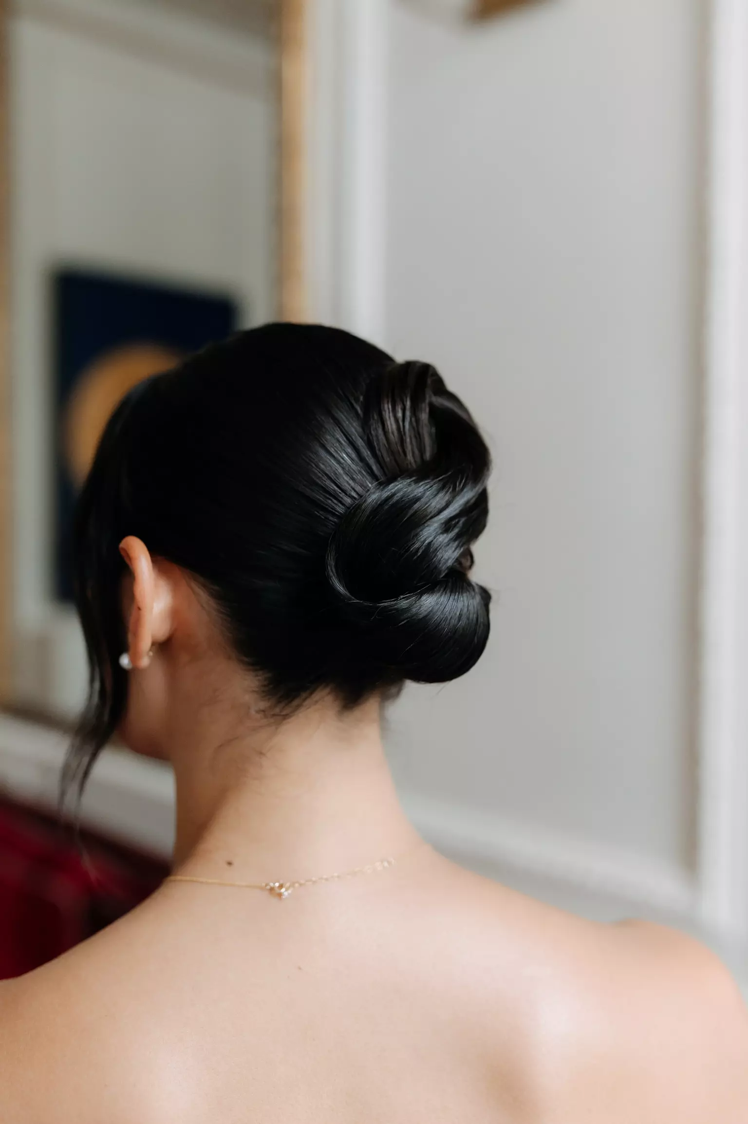 Close up of sleek low bridal bun showcasing technical hairstyling expertise by Mandy Dorian