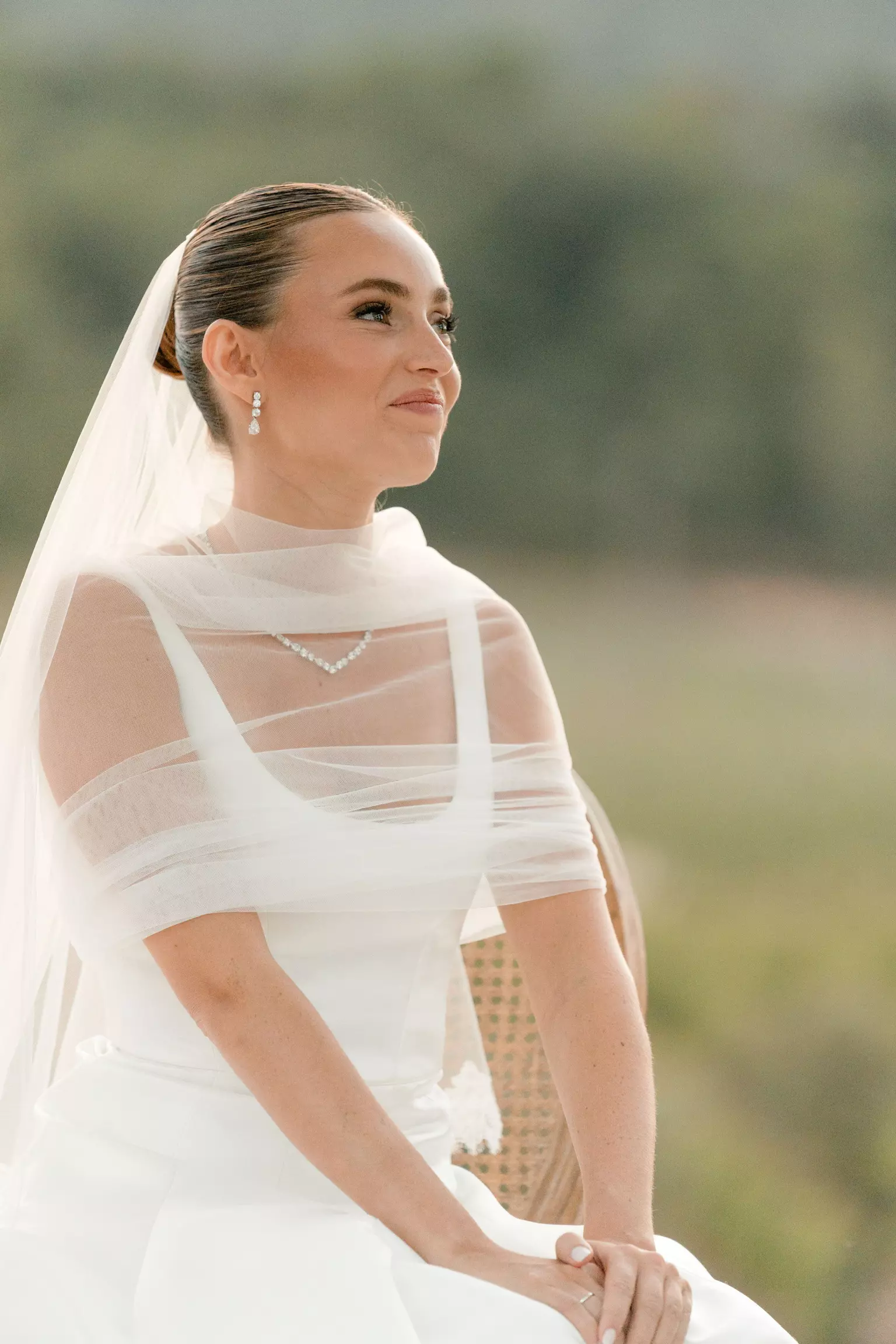 Bride wearing sheer neckline gown with refined bridal hair and radiant makeup by Mandy Dorian