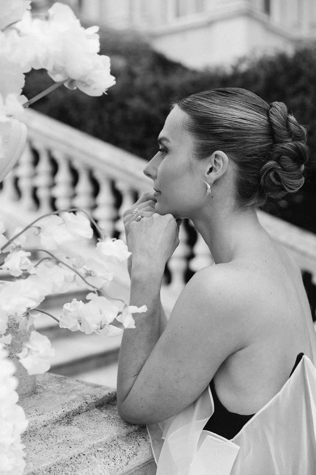Side profile of bride with sleek low bun and natural refined bridal makeup at Château de Ferrières