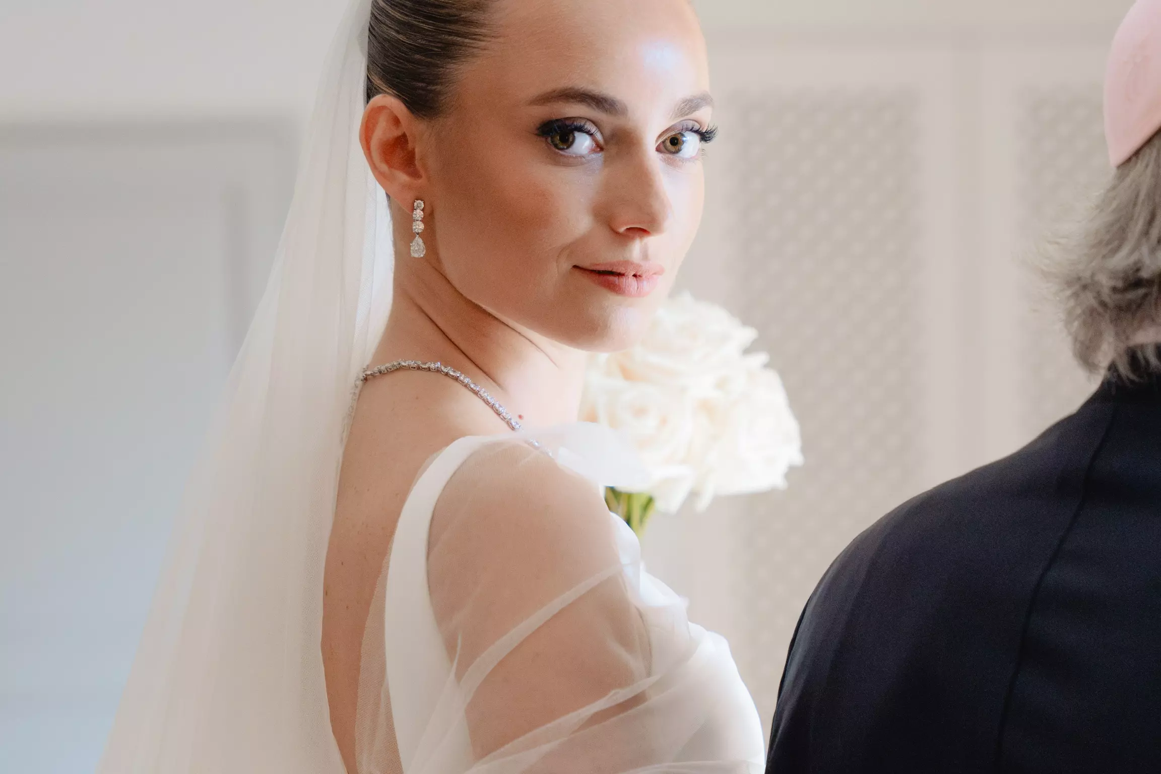 Bride Joan with luminous complexion and sleek bridal hairstyle overlooking Saint-Tropez