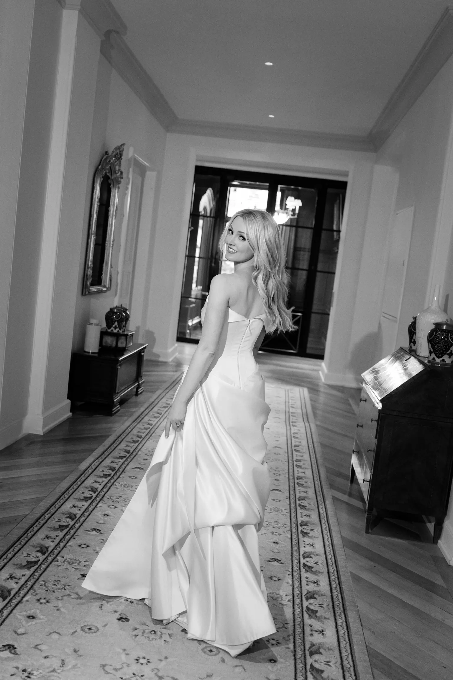 Full length portrait of bride featuring sculpted hairstyle and polished bridal makeup by Mandy Dorian