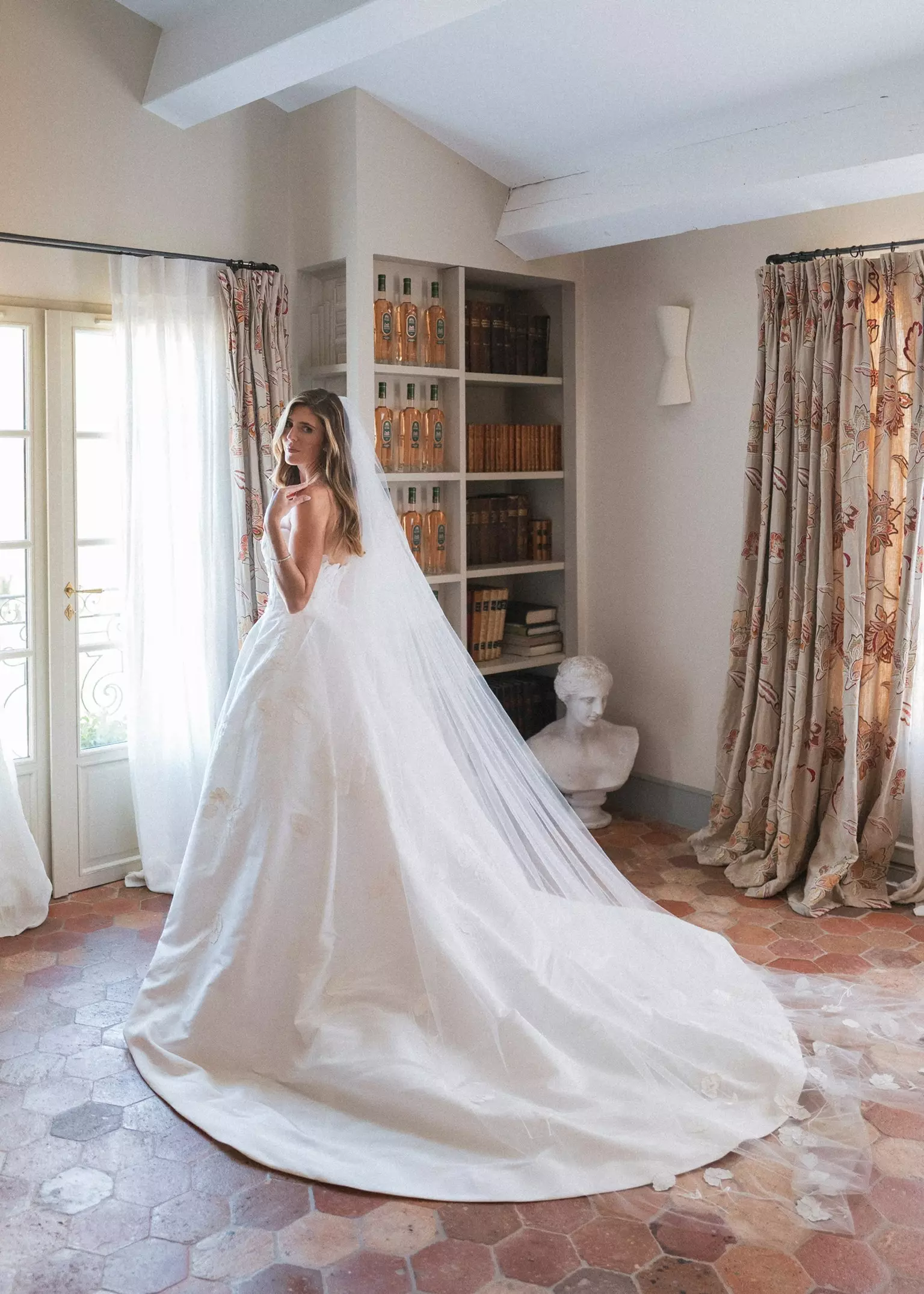 Bride wearing cathedral veil with refined bridal hairstyle and soft natural makeup