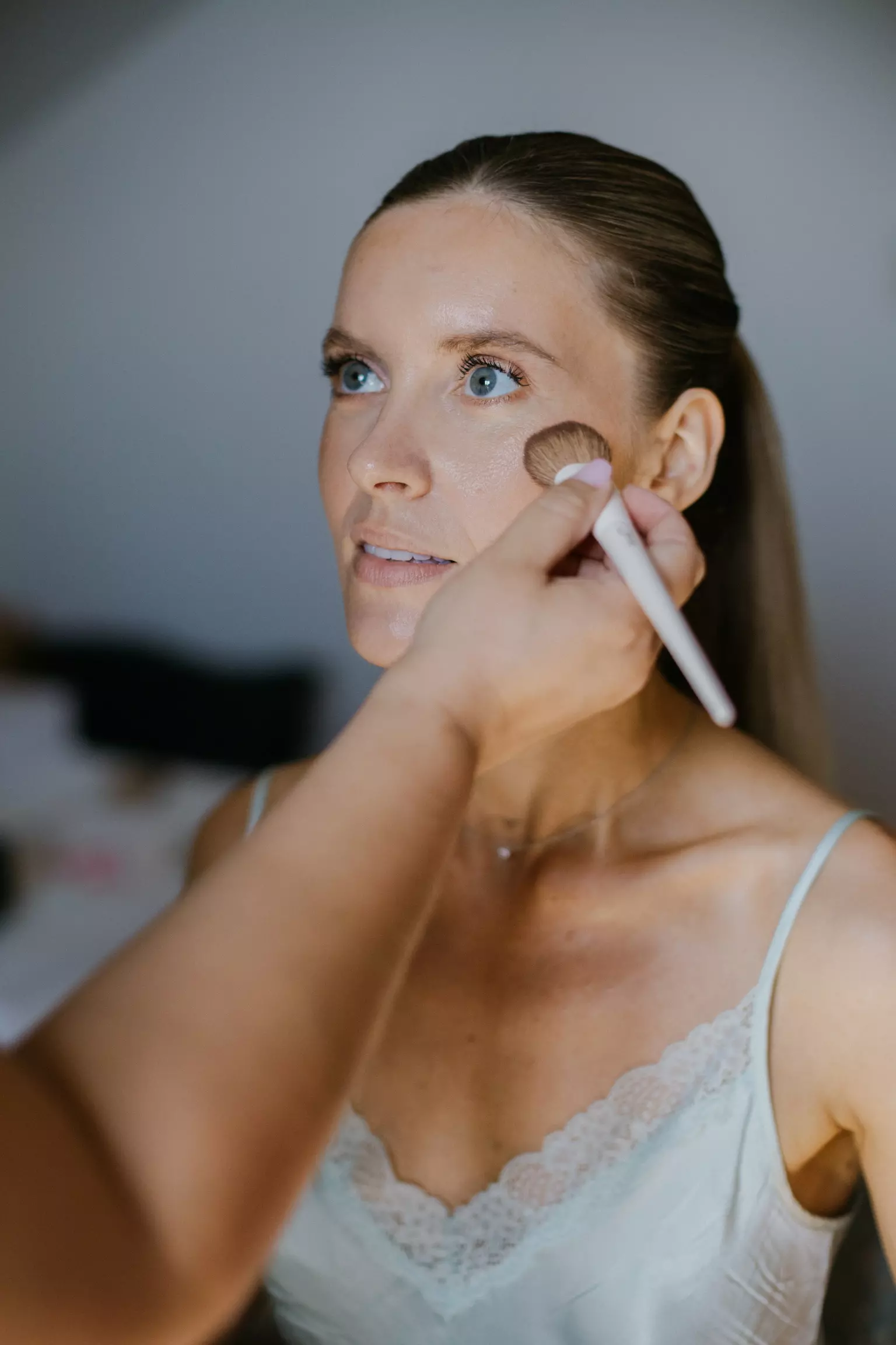 Mandy Dorian applying soft natural makeup to bride ensuring flawless complexion for wedding day