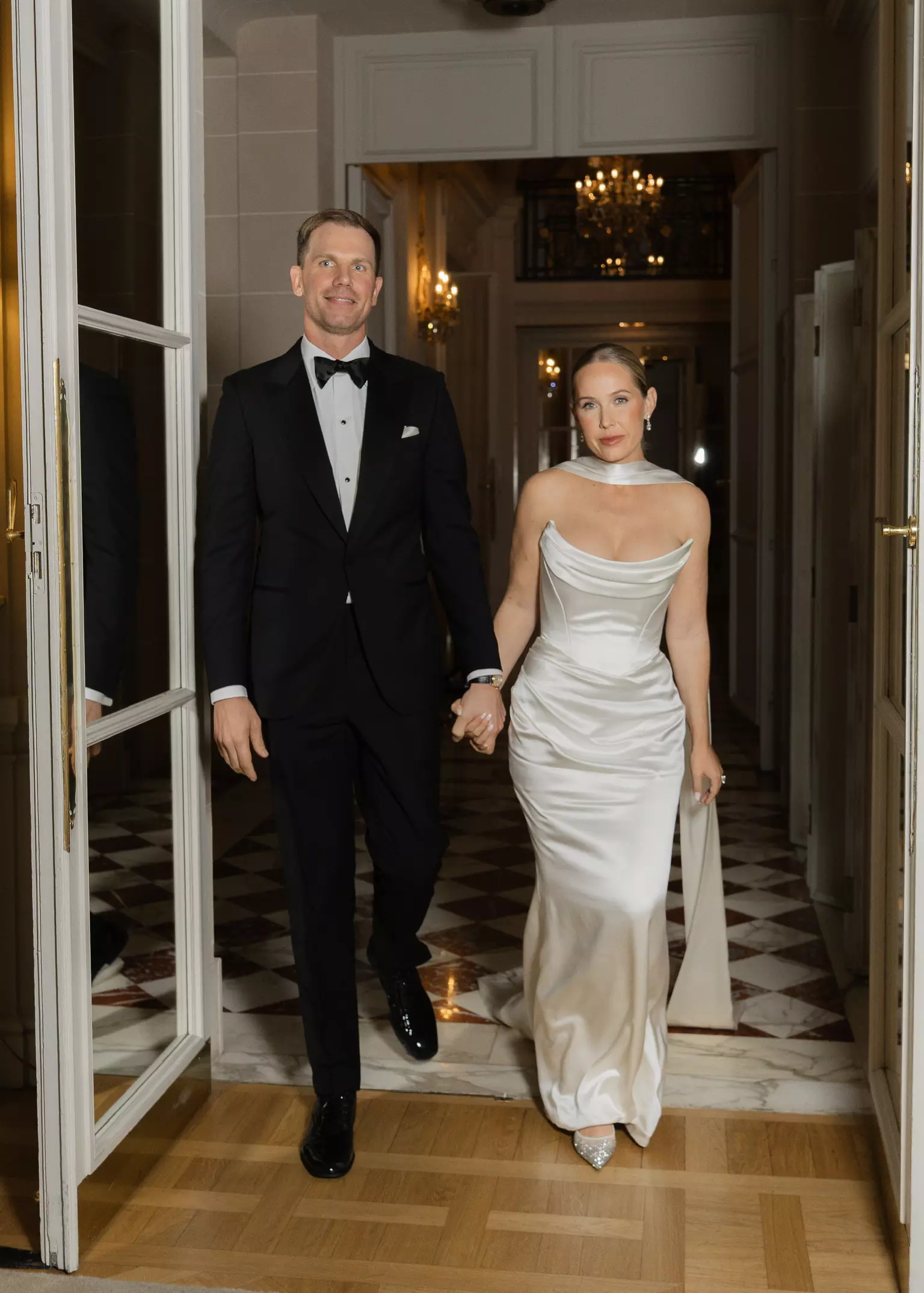 Bride and groom entering reception with second refined bridal beauty look created for evening celebration