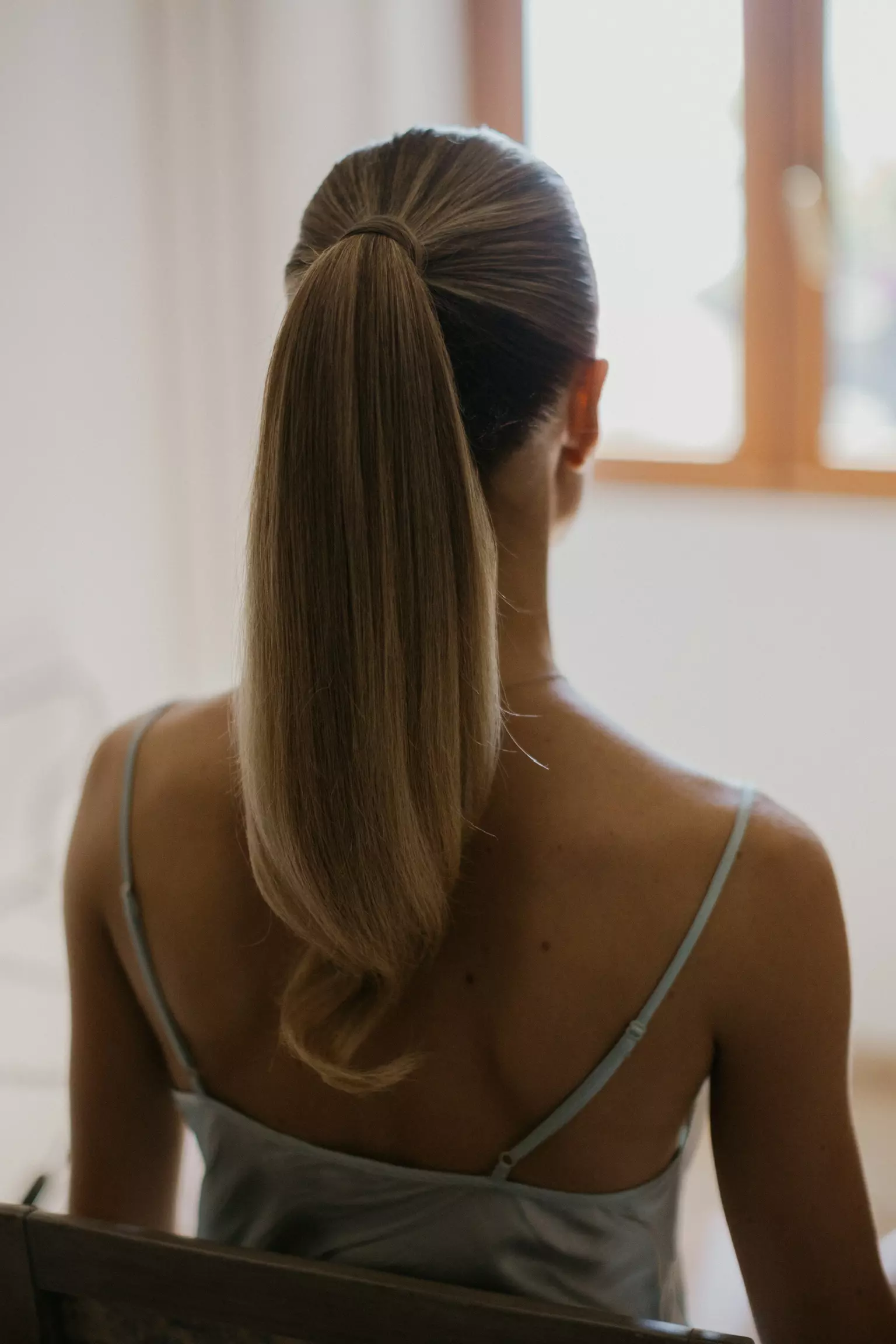 Back view of sleek high ponytail showcasing versatile bridal hairstyling by Mandy Dorian