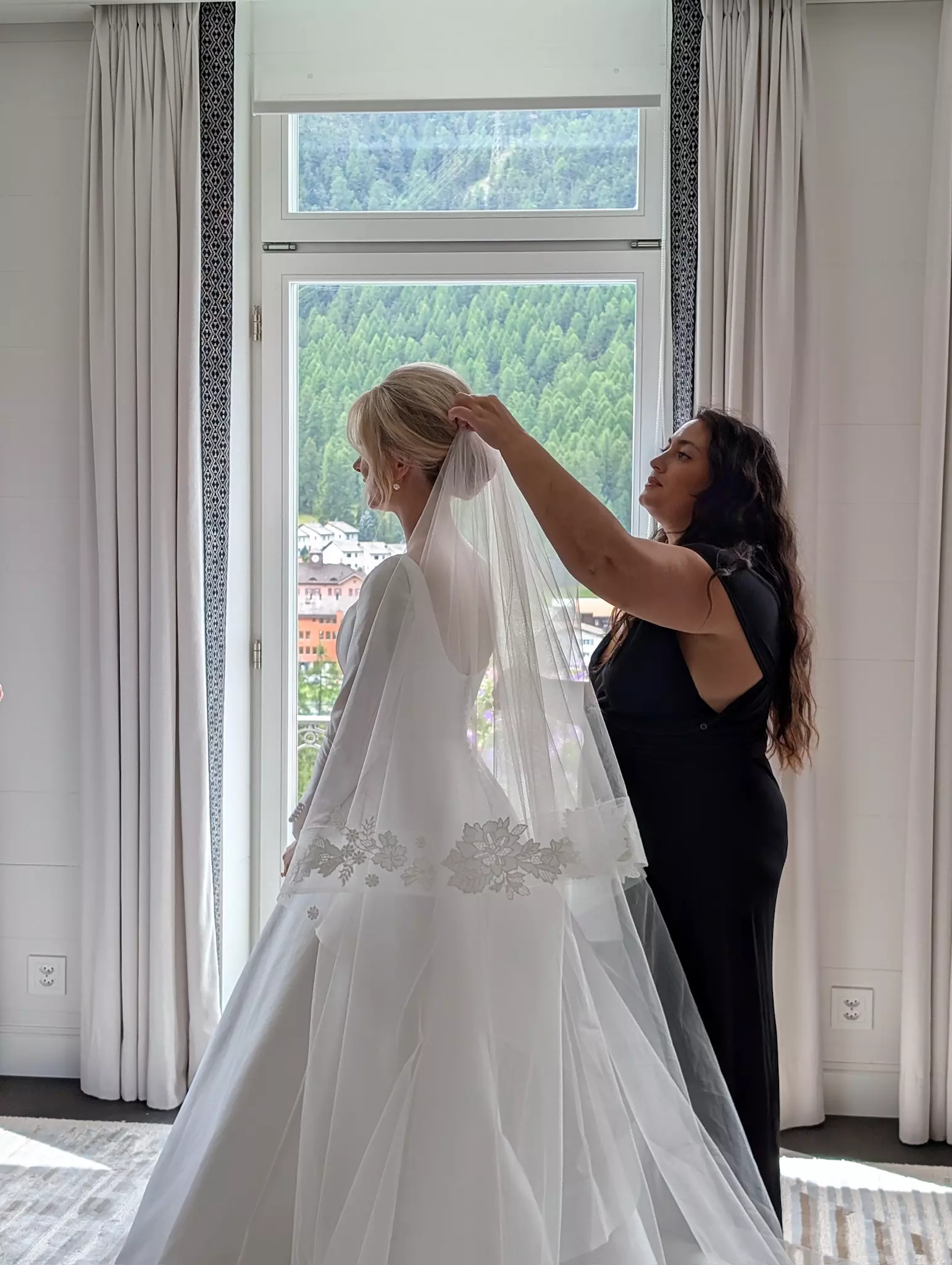 Mandy Dorian adjusting bride’s veil ensuring flawless bridal hairstyle