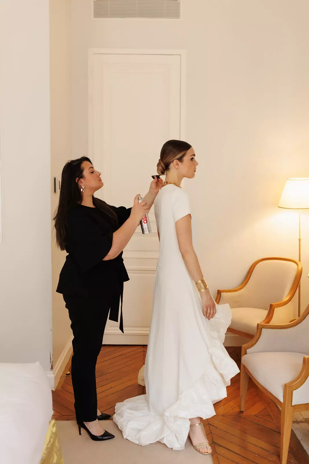 Mandy Dorian styling bride in wedding gown during preparation moment